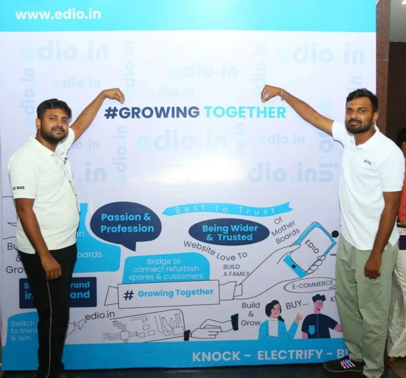 EDIO's founders, Prasanth and Suresh, pointing to a #GrowingTogether banner, with their names written above them