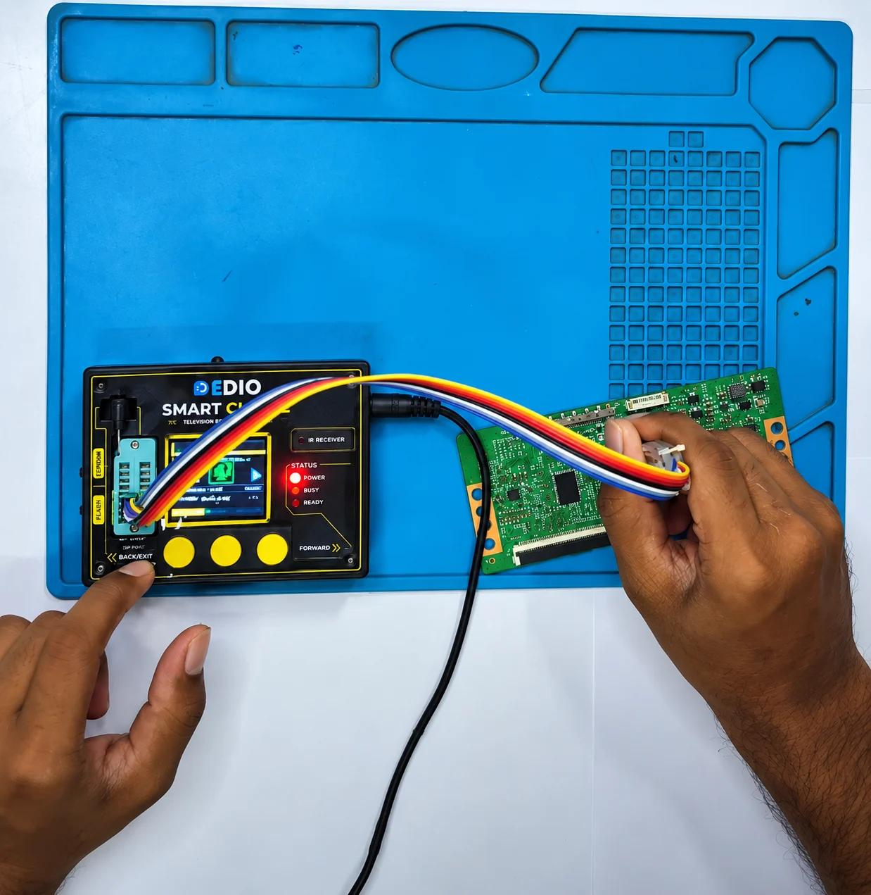 A technician connects SmartClone to a T-CON board on a repair mat